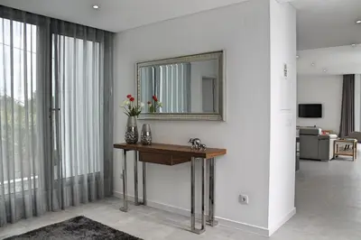 a bathroom with a sink and a mirror on a wall at Luxury Calheta Villa Casa Calheta Heights 3 Bedrooms Stunning Sea Views in Calheta
