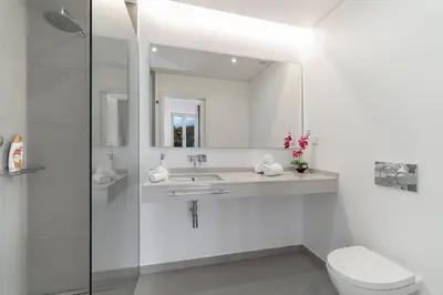 a bathroom with a sink and a toilet and a mirror at Luxury Calheta Villa Casa Calheta Heights 3 Bedrooms Stunning Sea Views in Calheta