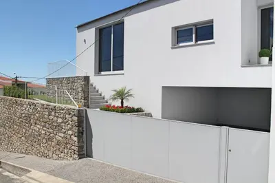a white house with a stone wall at Luxury Calheta Villa Casa Calheta Heights 3 Bedrooms Stunning Sea Views in Calheta