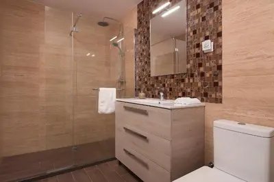 a bathroom with a toilet and a sink and a shower at Luxury Calheta Villa Casa Da Rosalina 5 Bedrooms Stunning Sea Views in Calheta