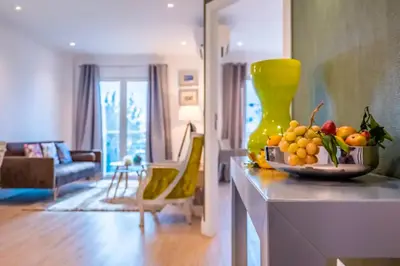 a living room with a bowl of fruit on a counter at Funchal Center Apartment II in Funchal