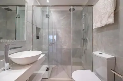 a bathroom with a shower and a sink and a toilet at Funchal Center Apartment II in Funchal