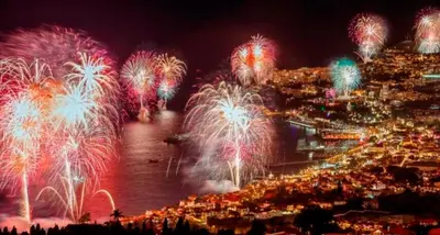 a fireworks display over a city with a river at Funchal Center Apartment II in Funchal