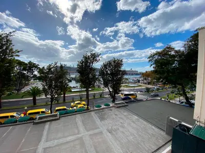 a parking lot with yellow taxis and a street at Funchal Center Apartment II in Funchal