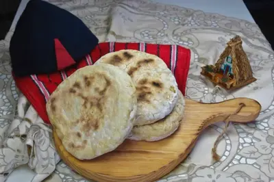 two pies on a wooden plate on a table at Funchal Center Apartment II in Funchal
