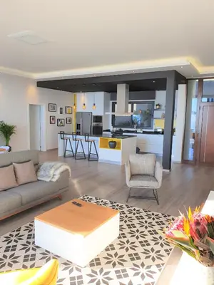 a living room with a couch and a kitchen at Villa Brava Atlântico in Ribeira Brava