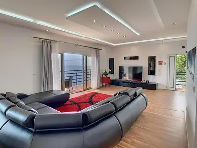 a large living room with a large leather couch at Villa Prainha by LovelyStay in Caniçal