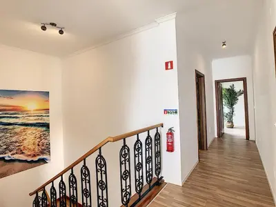 a staircase in a home with white walls at Villa Prainha by LovelyStay in Caniçal