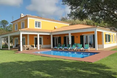 a house with a swimming pool in front of it at Bellevue Villa Madeira Magnificent Sea View in Prazeres