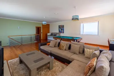 a living room with a couch and a pool table at Bellevue Villa Madeira Magnificent Sea View in Prazeres