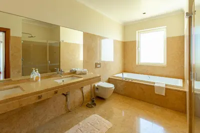 a bathroom with a tub and a sink and a toilet at Bellevue Villa Madeira Magnificent Sea View in Prazeres