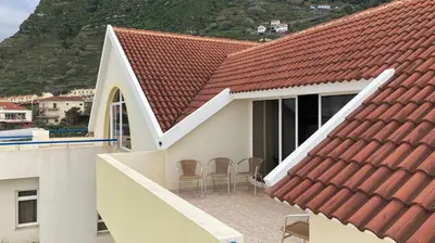 a view of a house with a red roof at Costa Azul in Porto Moniz