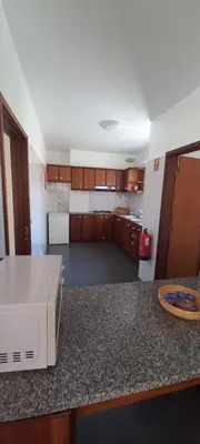 a kitchen with a counter top with a microwave at Costa Azul in Porto Moniz