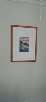 a picture on a white wall with a frame at Costa Azul in Porto Moniz