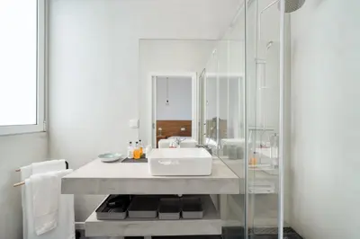 a bathroom with a sink and a glass shower at Casa Luz by LovelyStay in Prazeres