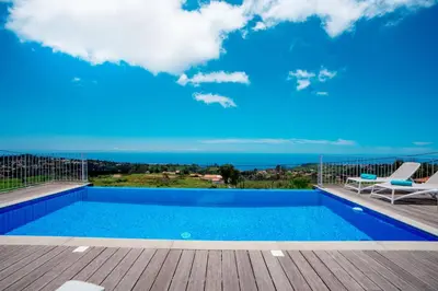 a swimming pool on a deck with a view of the ocean at Casa Luz by LovelyStay in Prazeres