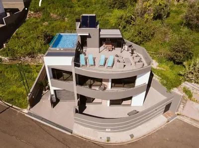 an aerial view of a house with a swimming pool at Villa Belmonte by LovelyStay in Ponta do Sol