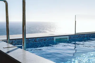 a swimming pool with a view of the ocean at Villa Belmonte by LovelyStay in Ponta do Sol