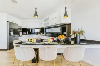 a kitchen with a large island with white cabinets at Villa Belmonte by LovelyStay in Ponta do Sol