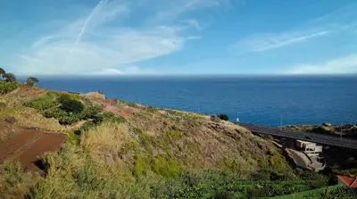 a view of the ocean from a hill with a train track at Sea View by Atlantic Holiday in Caniço
