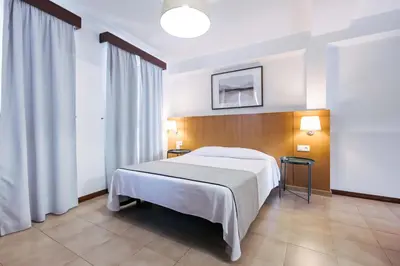 a white bathroom with a toilet and a sink at Murças74 - Studio Apartments in Funchal