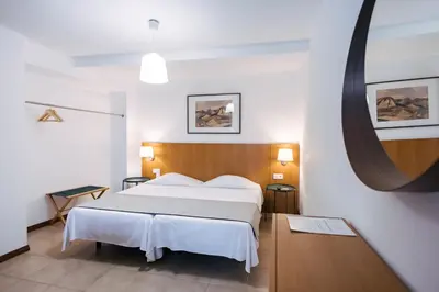 a bedroom with a bed and a table and a kitchen at Murças74 - Studio Apartments in Funchal