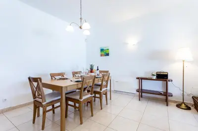 a dining room with a wooden table and chairs at CoolHouses Algarve Lagos, V3 Casa Evasion in Lagos