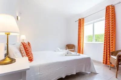 a white bedroom with a bed and a window at CoolHouses Algarve Lagos, V3 Casa Evasion in Lagos