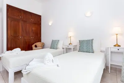 a bedroom with two beds and two tables and two lamps at CoolHouses Algarve Lagos, V3 Casa Evasion in Lagos