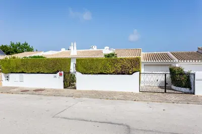 a white house with a fence and ivy on it at CoolHouses Algarve Lagos, V3 Casa Evasion in Lagos