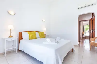 a bedroom with a white bed with a sink at CoolHouses Algarve Lagos, V3 Casa Evasion in Lagos