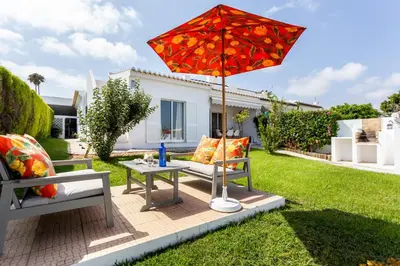 a patio with a table and an umbrella at CoolHouses Algarve Lagos, V3 Casa Evasion in Lagos