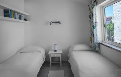 two twin beds in a room with a window at Two bedroom apartment with garden view in Luz in Luz