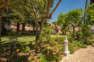 a garden with a lighthouse in the middle of a park at Two bedroom apartment with garden view in Luz in Luz