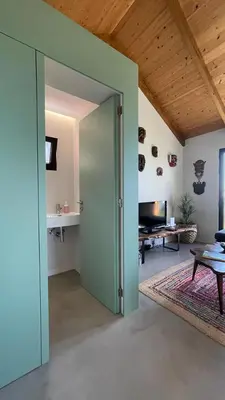 a room with an open door to a living room at Mango House in Arco da Calheta