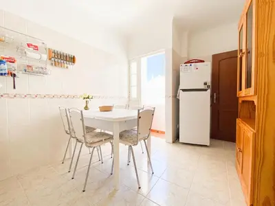 a kitchen with a white table and chairs and a refrigerator at Retreat with Terrace and View in Espiche #1887 in Espiche