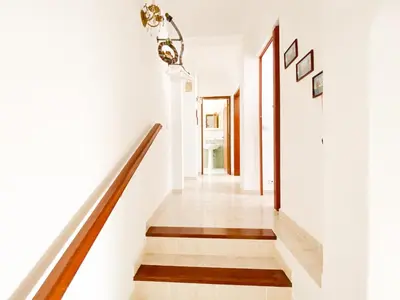 a staircase in a house with white walls and wooden floors at Retreat with Terrace and View in Espiche #1887 in Espiche
