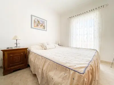 a bedroom with a large bed and a window at Retreat with Terrace and View in Espiche #1887 in Espiche