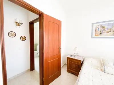 a bedroom with a bed and a wooden door at Retreat with Terrace and View in Espiche #1887 in Espiche