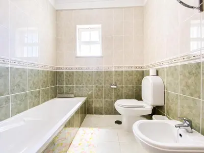 a bathroom with a tub and a toilet and a sink at Retreat with Terrace and View in Espiche #1887 in Espiche