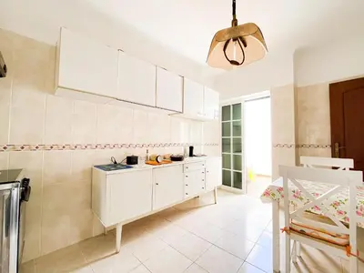 a kitchen with white cabinets and a pendant light at Simple Beach Lovers' Retreat in Espiche #1888 in Espiche