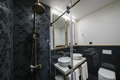a bathroom with two sinks and a mirror at Madeira Gems Apartments in Funchal
