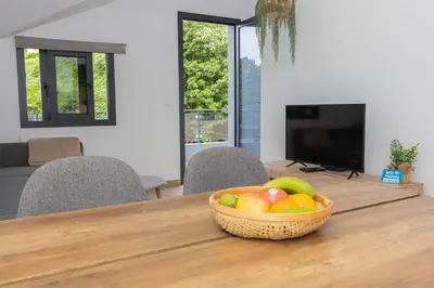 a bowl of fruit sitting on a wooden table at Ilha Natura in Santana