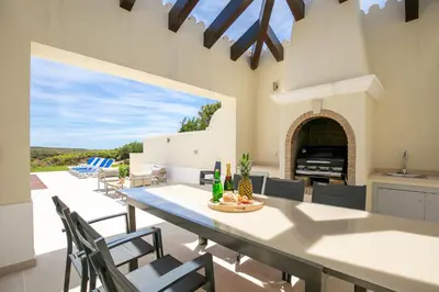 a kitchen and dining room with a large table and chairs at Sea View Villa in Sagres
