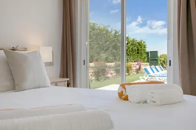 a bedroom with a bed with a view of a patio at Sea View Villa in Sagres