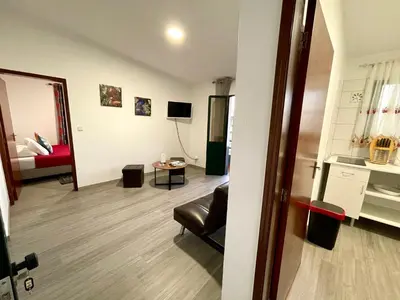 a living room with a couch and a bed in a room at Sunset Star with Sea View in Calheta