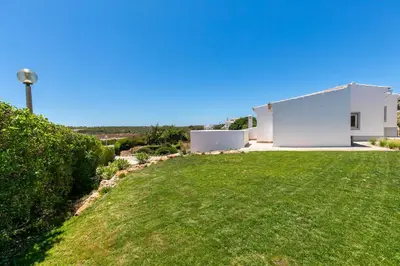 a view of a yard with a white house at Beach Villa - oceanfront villa Martinhal in Sagres
