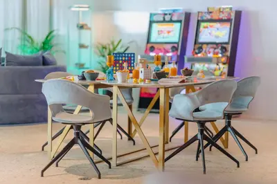 a table with chairs and a table with food on it at NEXT - by Savoy Signature in Funchal