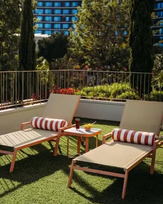 a bedroom with a large white bed and a desk and a window at NEXT - by Savoy Signature in Funchal