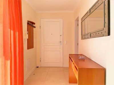 a hallway with a door and a table in a room at Charming Calheta Plaza Penthouse in Calheta